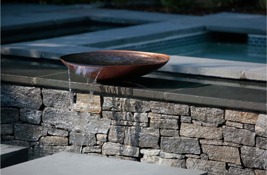 title:The beautiful copper bowl was hand crafted by a Pennsylvania artisan. The bowl gently spills its content into to the pool.