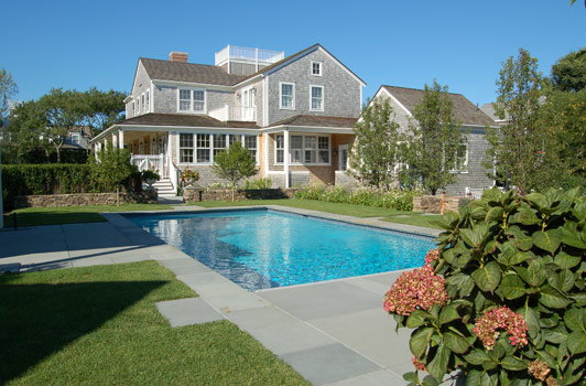 title:View North towards the main house from the guest bedroom patio. Pear trees help separate the pool from the parking courtyard.