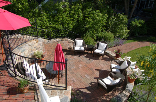 title:The middle patio serves as an afternoon hang out area. A high retaining wall at the back provides shelter, while the one at the front of the circular space creates a promontory aspect from which to view the garden below.